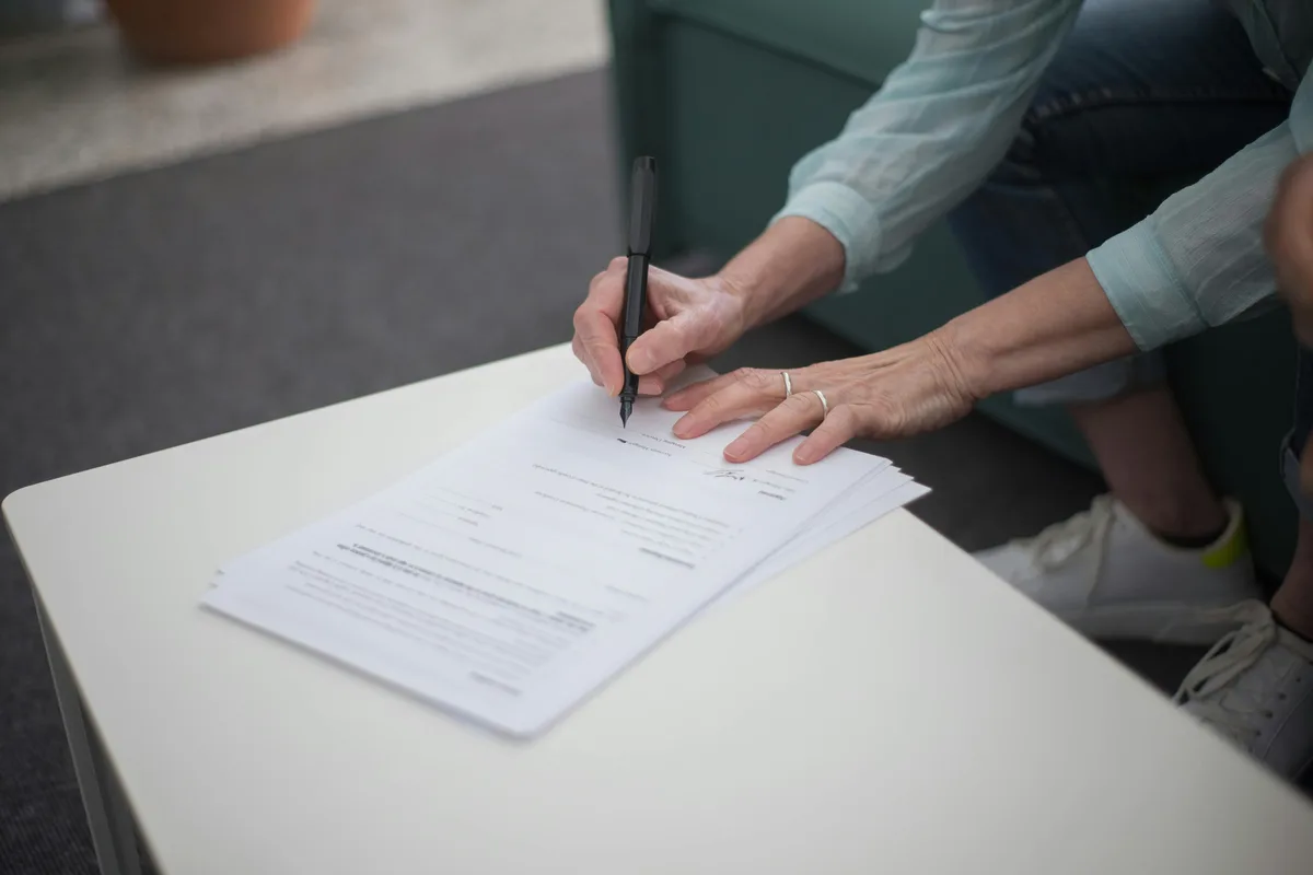 Person signing loan agreement — the final step before FineDay Funds deposits your money