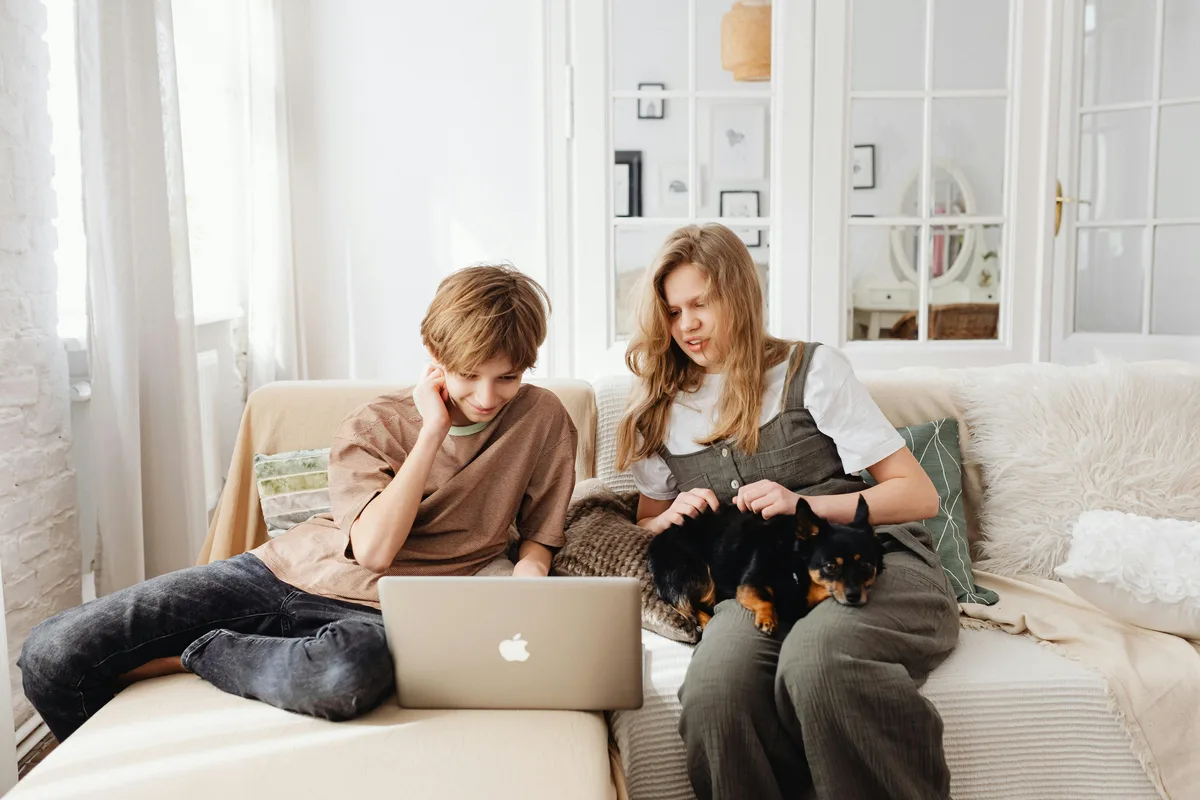 Young people browsing FineDay Funds loan application on laptop at home